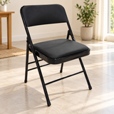 Silla plegable negra 40x76x40 cm en interior luminoso — 30-212-174